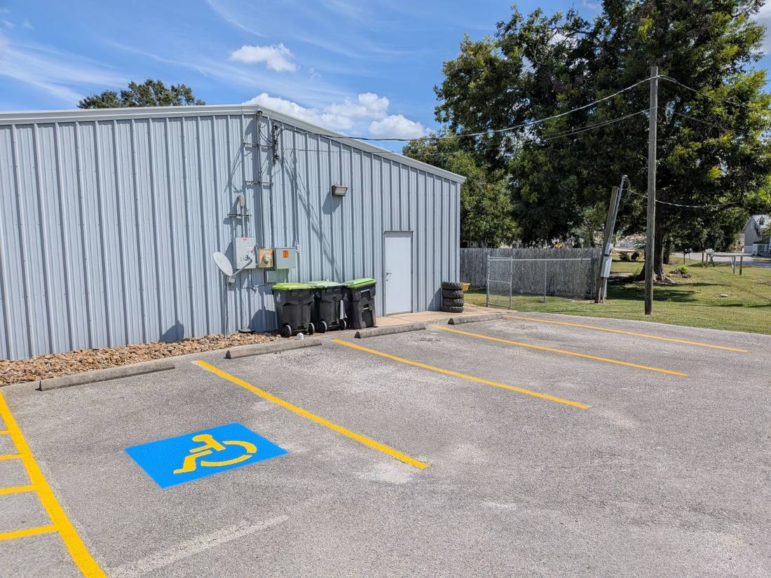 Freshly painted blue and yellow ADA accessible parking symbol in a repainted stall