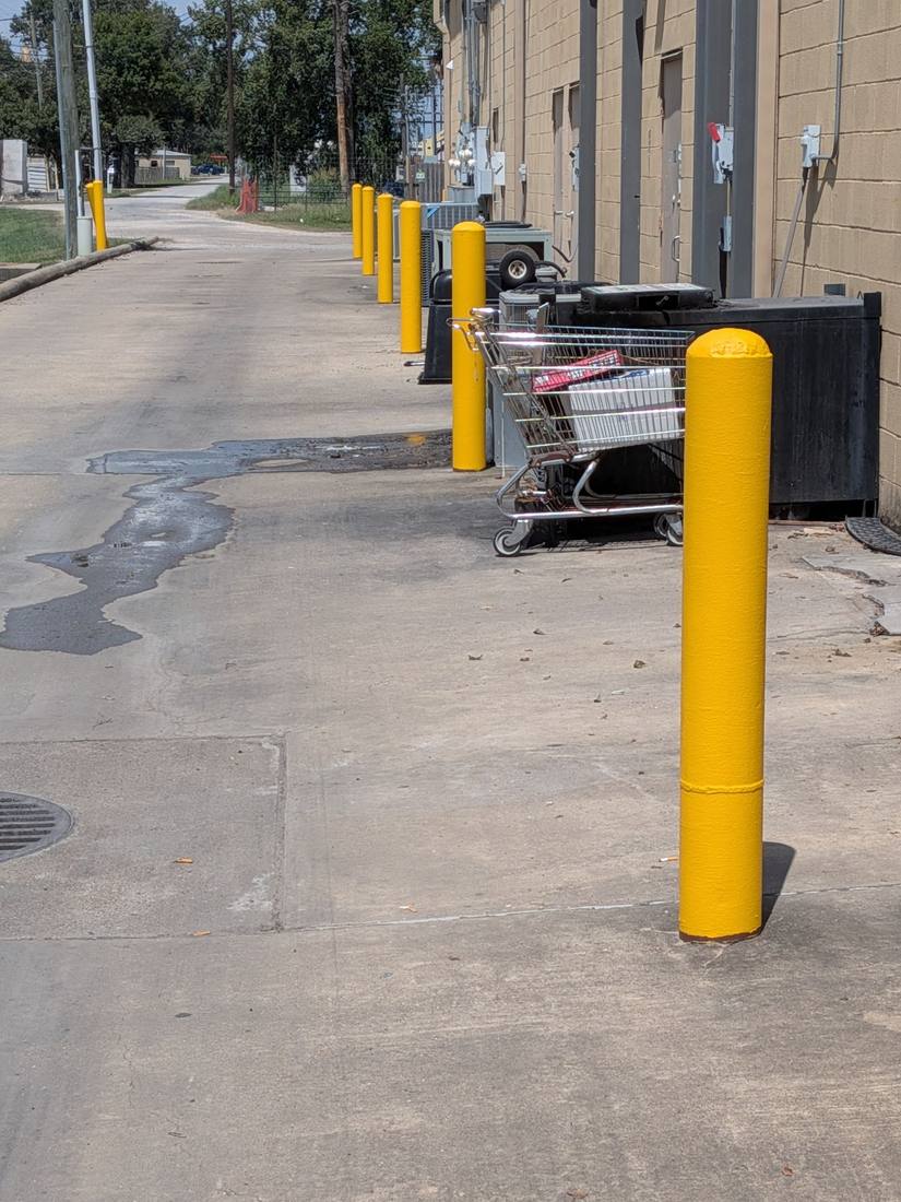The same line of bollards finished in three coats of safety yellow