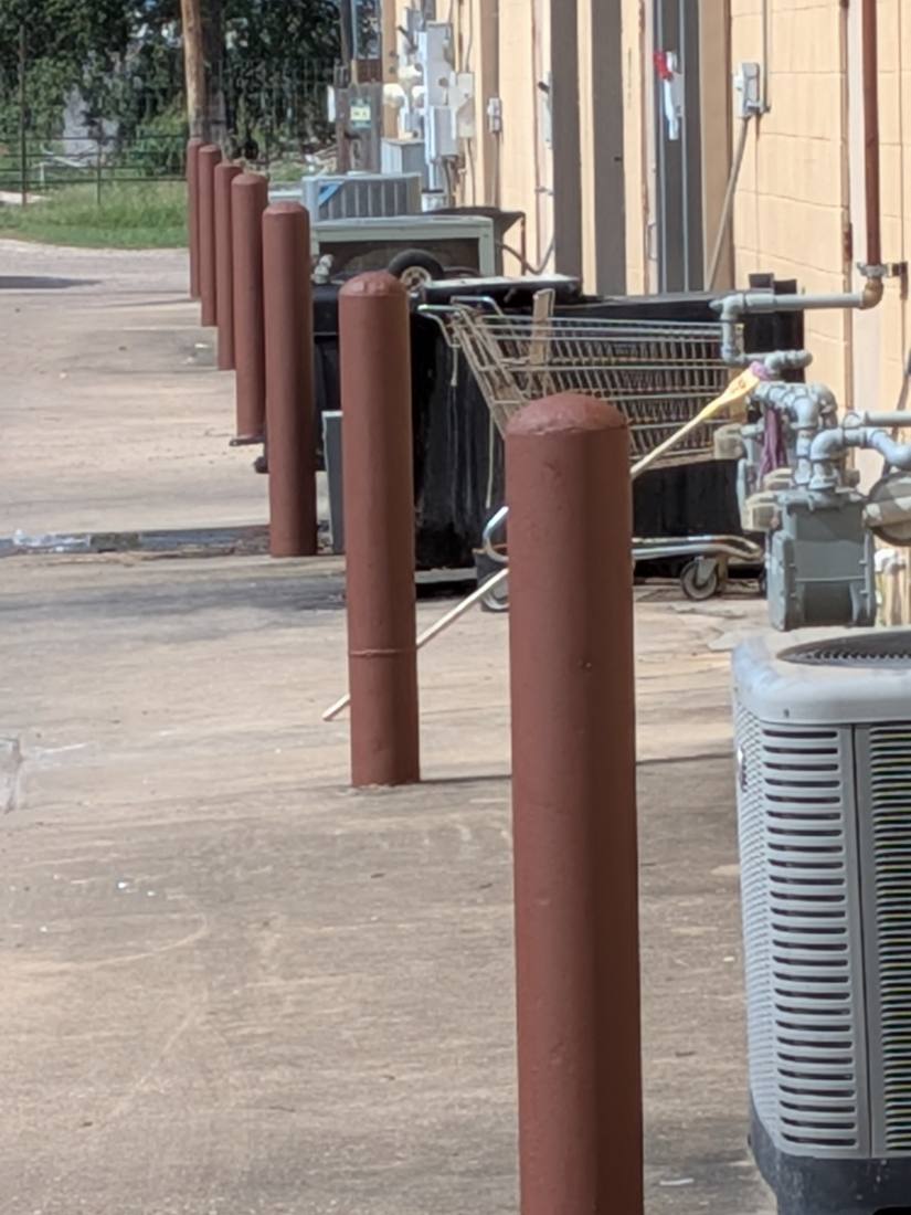 Bollards coated in red-oxide rust-inhibiting primer before the yellow topcoats