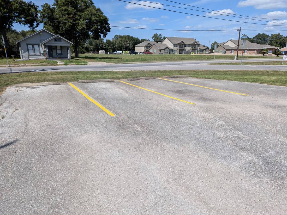 The same parking lot after restriping with fresh yellow stall lines
